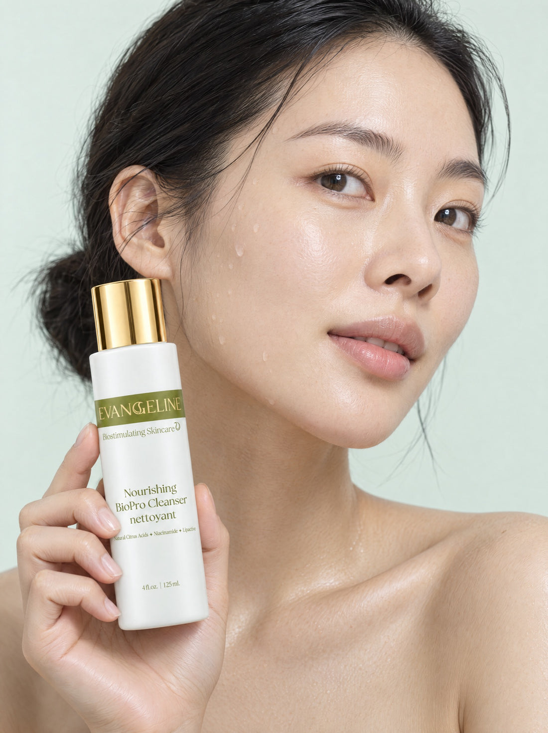 Woman with freshly cleansed skin holding Evangeline Nourishing BioPro Cleanser