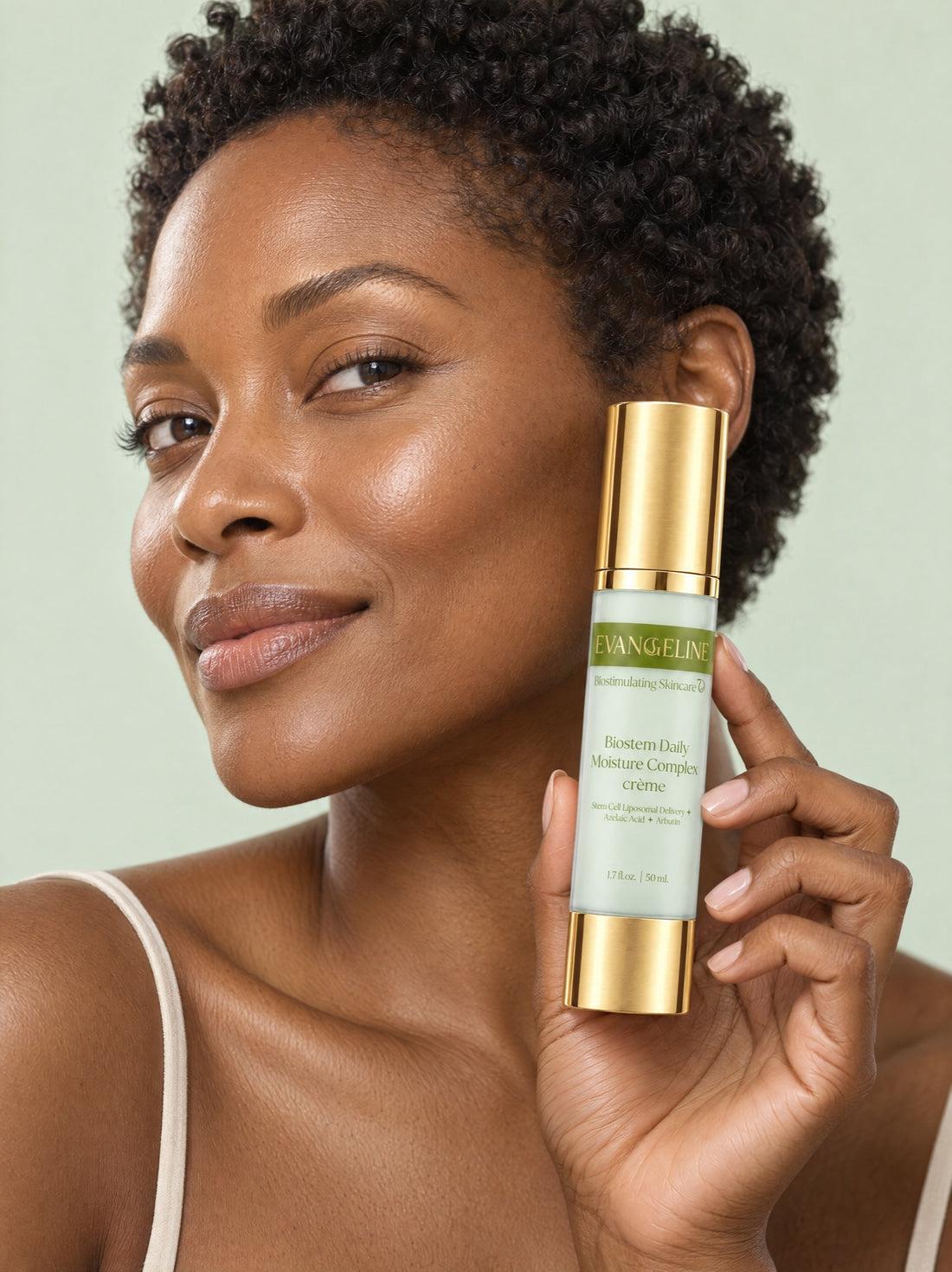 Woman holding Evangeline Biostem Daily Moisture Complex beside her face